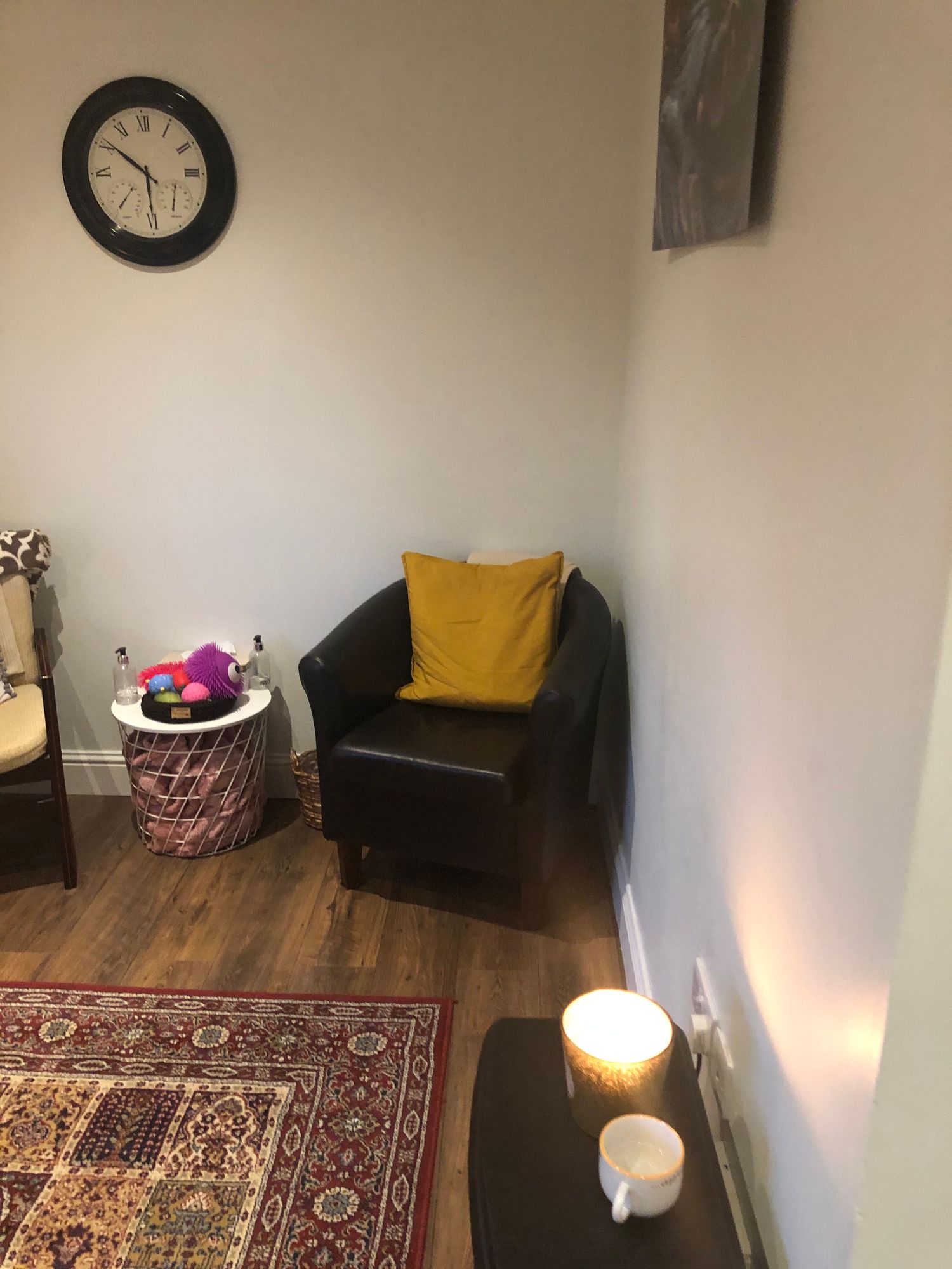 Cozy therapy room corner with comfortable armchair and warm lighting at Release Counselling Services